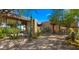 This home features desert landscaping, stone walls, and modern windows with beautiful views at 30600 N Pima Rd # 61, Scottsdale, AZ 85266