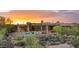 Desert home featuring a sparkling pool, outdoor seating, and beautiful desert landscaping at sunset at 30600 N Pima Rd # 61, Scottsdale, AZ 85266