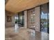 Sun-filled foyer with tile floors, brick accents, and glass doors to outdoor gardens at 30600 N Pima Rd # 61, Scottsdale, AZ 85266