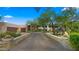 Desert landscaping and brick driveway lead to this charming, flat-roofed home with a two-car garage at 30600 N Pima Rd # 61, Scottsdale, AZ 85266