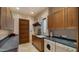 Well-equipped laundry room with modern washer, dryer, wooden cabinets, sink and ample counter space for laundry needs at 30600 N Pima Rd # 61, Scottsdale, AZ 85266