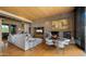 Spacious living room featuring a stone fireplace, hardwood floors, and comfortable seating arrangement at 30600 N Pima Rd # 61, Scottsdale, AZ 85266