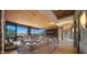 Open-concept living room with floor-to-ceiling windows, tile floors, a sectional sofa, and direct access to the outdoor patio at 30600 N Pima Rd # 61, Scottsdale, AZ 85266