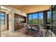 Stylish living room with a built-in bar, modern furnishings, and a view of the desert landscape at 30600 N Pima Rd # 61, Scottsdale, AZ 85266