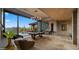 Bright living room featuring a pool table, fireplace, and a wall of glass overlooking the pool and desert landscape at 30600 N Pima Rd # 61, Scottsdale, AZ 85266