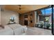 Spacious main bedroom featuring a fireplace, brick walls, a king bed and floor to ceiling windows at 30600 N Pima Rd # 61, Scottsdale, AZ 85266