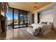 Main bedroom featuring a fireplace, patio access, and exterior views at 30600 N Pima Rd # 61, Scottsdale, AZ 85266