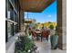 Inviting outdoor dining area with a built-in grill, desert views, and wall-mounted television at 30600 N Pima Rd # 61, Scottsdale, AZ 85266