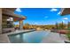 A luxurious pool with desert landscaping, a fire pit, and outdoor seating for relaxation at 30600 N Pima Rd # 61, Scottsdale, AZ 85266