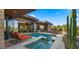 A luxurious pool and hot tub area featuring desert landscaping and architectural design at 30600 N Pima Rd # 61, Scottsdale, AZ 85266