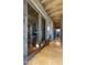 Elegant entryway to the wine cellar with glass doors and brick walls at 30600 N Pima Rd # 61, Scottsdale, AZ 85266