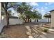 Spacious backyard with trees and a white block fence providing privacy at 3218 W Clinton St, Phoenix, AZ 85029