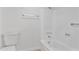 The bathroom has a white toilet and a built-in white tub/shower with silver hardware at 3218 W Clinton St, Phoenix, AZ 85029