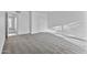 Bedroom with gray carpet, white walls, closet doors, and an attached doorway at 3218 W Clinton St, Phoenix, AZ 85029