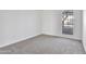 Empty bedroom boasts carpet and natural light from the window at 3218 W Clinton St, Phoenix, AZ 85029