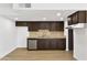 Well-lit kitchen featuring wood cabinets, stone countertops, stainless dishwasher, and tile backsplash at 3218 W Clinton St, Phoenix, AZ 85029