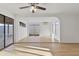 Bright open layout featuring light wood floors, a ceiling fan, and access to the outdoor patio at 3218 W Clinton St, Phoenix, AZ 85029