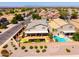 Stunning aerial view of a home with a private backyard featuring a pool, outdoor kitchen, and serene landscaping at 3597 W Mineral Butte Dr, San Tan Valley, AZ 85144