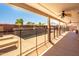 Spacious covered patio offering shade and views of the fenced pool area and well-maintained landscaping at 3597 W Mineral Butte Dr, San Tan Valley, AZ 85144