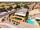 An aerial view of a home showcasing the backyard pool, covered patio, and desert landscaping at 3597 W Mineral Butte Dr, San Tan Valley, AZ 85144