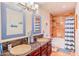 Bathroom featuring double vanity, granite countertop, framed mirrors, and tiled shower at 3597 W Mineral Butte Dr, San Tan Valley, AZ 85144