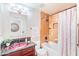 Stylish bathroom with a unique pink-toned sink and a shower-tub combo with decorative stone tiles at 3597 W Mineral Butte Dr, San Tan Valley, AZ 85144