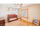 Bedroom/Bedroom with charming monkey-themed wall art and shuttered window at 3597 W Mineral Butte Dr, San Tan Valley, AZ 85144