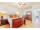 Relaxing bedroom with a classic wooden bed frame, complemented by matching nightstands and a dresser at 3597 W Mineral Butte Dr, San Tan Valley, AZ 85144