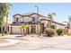 This two-story home has a three car garage, tasteful landscaping with palm trees, and a neutral exterior at 3597 W Mineral Butte Dr, San Tan Valley, AZ 85144