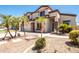 Inviting exterior highlights a meticulously landscaped front yard, mature palms, and charming stone accents at 3597 W Mineral Butte Dr, San Tan Valley, AZ 85144