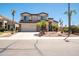 A charming two-story home with a three car garage complemented by mature palm trees in a manicured front yard at 3597 W Mineral Butte Dr, San Tan Valley, AZ 85144