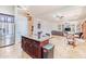 Spacious open-concept kitchen with dark wood cabinetry and island, seamlessly connected to living spaces at 3597 W Mineral Butte Dr, San Tan Valley, AZ 85144