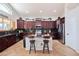 Spacious kitchen features dark wood cabinets, granite counters, and large central island at 3597 W Mineral Butte Dr, San Tan Valley, AZ 85144