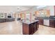 Open kitchen and living area with hardwood cabinets and island, great for entertaining at 3597 W Mineral Butte Dr, San Tan Valley, AZ 85144