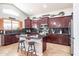 Well-appointed kitchen boasts dark wood cabinetry, granite countertops, and a center island for cooking and entertaining at 3597 W Mineral Butte Dr, San Tan Valley, AZ 85144