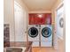 Efficient laundry room featuring matching washer and dryer, with cabinet space and a granite countertop at 3597 W Mineral Butte Dr, San Tan Valley, AZ 85144