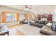 Open-concept living room with a kitchen view, complemented by natural light and a cozy seating arrangement at 3597 W Mineral Butte Dr, San Tan Valley, AZ 85144