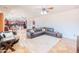 Spacious living room with a plush rug and a comfortable, large, leather sectional sofa for relaxation at 3597 W Mineral Butte Dr, San Tan Valley, AZ 85144