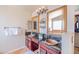 Double vanity in main bath featuring granite counters, wood cabinets, and bronze fixtures at 3597 W Mineral Butte Dr, San Tan Valley, AZ 85144
