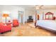 Spacious main bedroom with sitting area, four-poster bed, ceiling fan, and tile flooring at 3597 W Mineral Butte Dr, San Tan Valley, AZ 85144