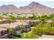 Neighborhood view with a mountain backdrop; Solar panels are visible on the roof at 3597 W Mineral Butte Dr, San Tan Valley, AZ 85144