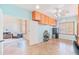Open home office area features custom cabinets, travertine tile flooring, and natural light at 3597 W Mineral Butte Dr, San Tan Valley, AZ 85144