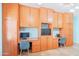 Custom-built office area with extensive cabinet storage, built-in desks, and neutral decor at 3597 W Mineral Butte Dr, San Tan Valley, AZ 85144
