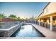 Inviting backyard oasis with a sparkling pool, stone accents, and relaxing lounge areas at 3597 W Mineral Butte Dr, San Tan Valley, AZ 85144