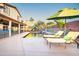 Relax by the refreshing pool with comfortable lounge chairs, verdant foliage, and a lovely rock waterfall feature at 3597 W Mineral Butte Dr, San Tan Valley, AZ 85144