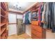 Walk-in closet features custom wood shelving and a decorative chandelier at 3597 W Mineral Butte Dr, San Tan Valley, AZ 85144