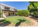 Charming backyard with a covered patio, lush lawn, and mature trees, perfect for outdoor living at 3821 W Barcelona Dr, Chandler, AZ 85226