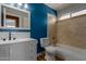 Bright bathroom showcases blue accent wall, white cabinets, and a shower over tub at 3821 W Barcelona Dr, Chandler, AZ 85226