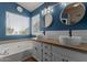 Modern bathroom with double sinks, wood counter, and bathtub at 3821 W Barcelona Dr, Chandler, AZ 85226