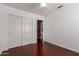 Bedroom features hardwood floors, ceiling fan, and white sliding-door closet for a clean, modern look at 3821 W Barcelona Dr, Chandler, AZ 85226